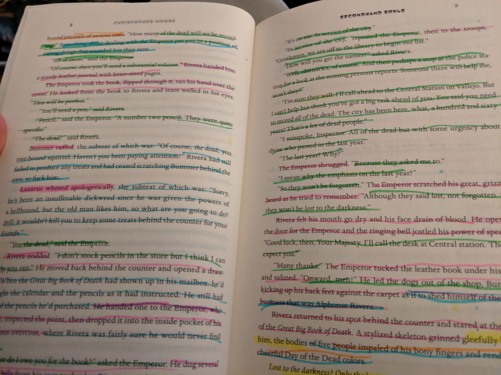 Open book pages with sentences color-coded in pink, blue, green and yellow highlighter